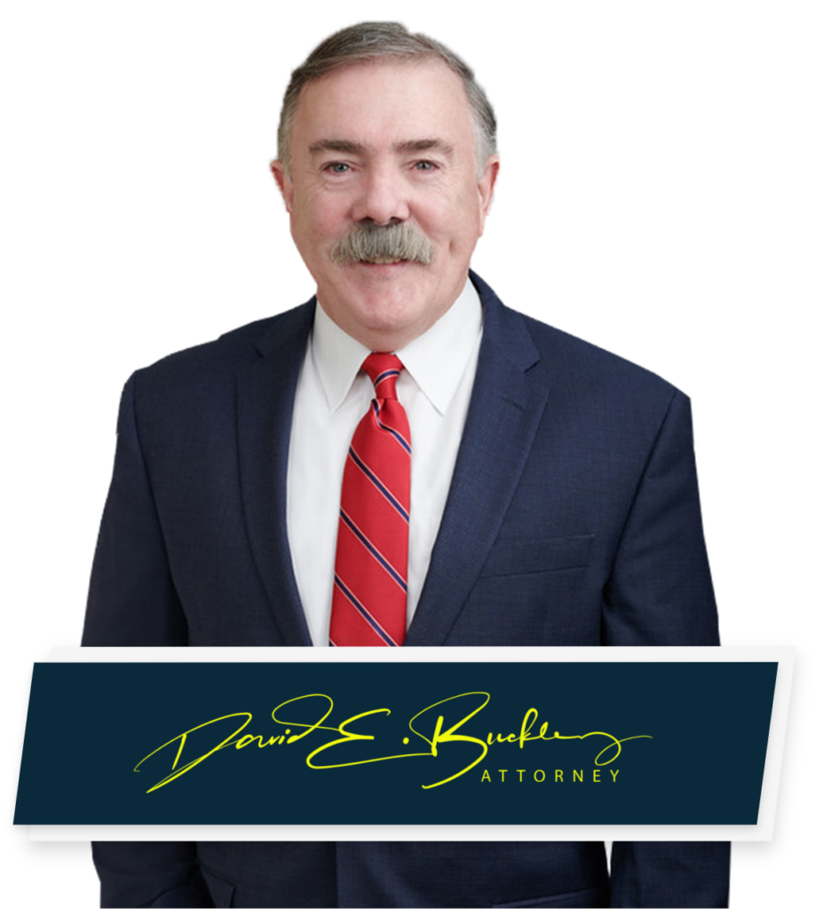 Hooksett Car Accident Lawyer David E Buckley poses for a headshot, and displays his signature at the bottom of the picture