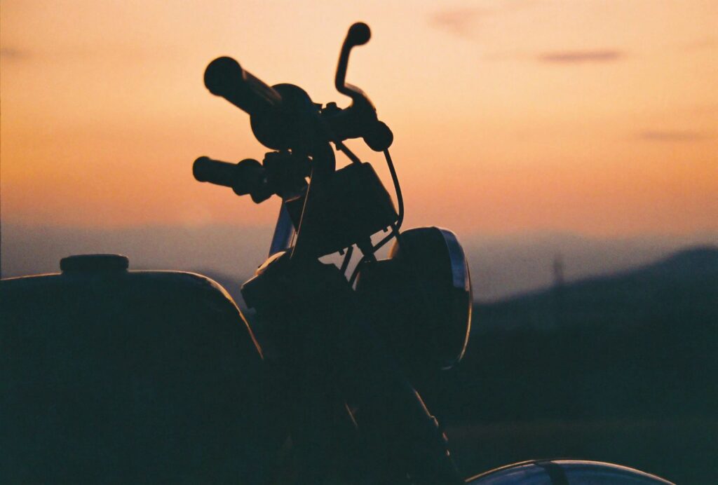 Hooksett Motorcycle Accident Lawyer features photo of parked motorcycle silhouette with sunrise behind it