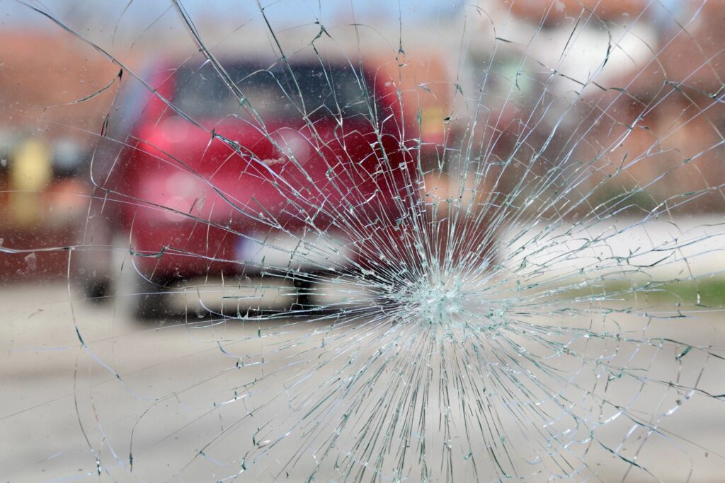 Hooksett Car Accident Lawyer features photo of broken glass and car pulled over after car accident